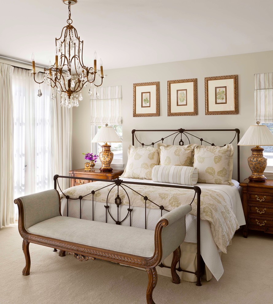 Inspiration for a traditional master bedroom in Denver with beige walls and carpet.