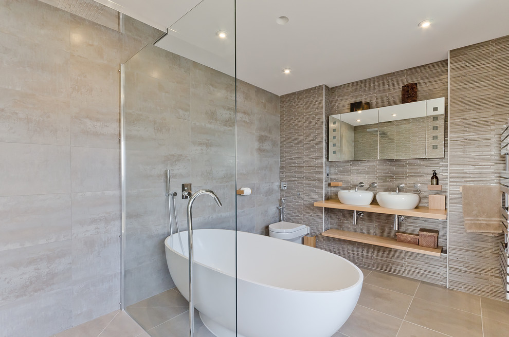 Inspiration for a mid-sized contemporary master bathroom in Surrey with a vessel sink, wood benchtops, a freestanding tub, an open shower, a wall-mount toilet, an open shower and beige benchtops.