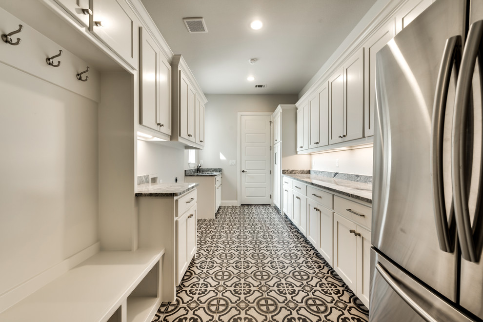 Design ideas for a large contemporary dedicated laundry room in Dallas with an undermount sink, shaker cabinets, white cabinets, quartz benchtops, beige walls, ceramic floors, a side-by-side washer and dryer and black floor.
