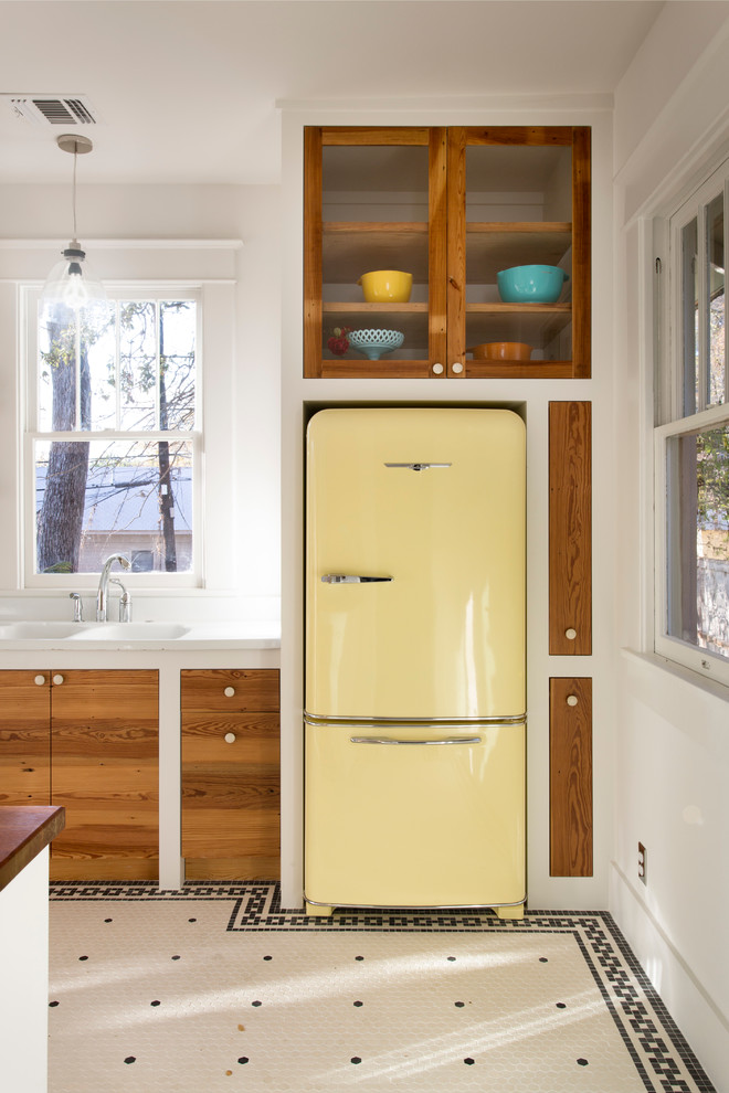 This is an example of an eclectic kitchen in Austin with coloured appliances.