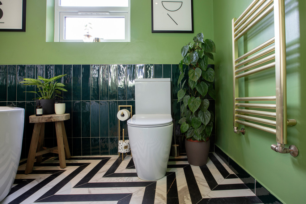 Photo of a medium sized victorian family bathroom in London with all styles of cabinet, a walk-in shower, green walls, multi-coloured floors, an open shower, a single sink and a floating vanity unit.
