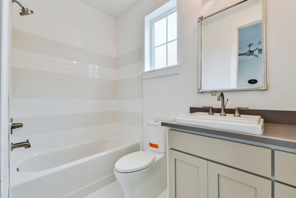 Small transitional kids bathroom in Austin with shaker cabinets, an alcove tub, a shower/bathtub combo, a one-piece toilet, white tile, subway tile, ceramic floors, a drop-in sink, engineered quartz benchtops, a shower curtain, grey benchtops, beige cabinets, white walls and white floor.