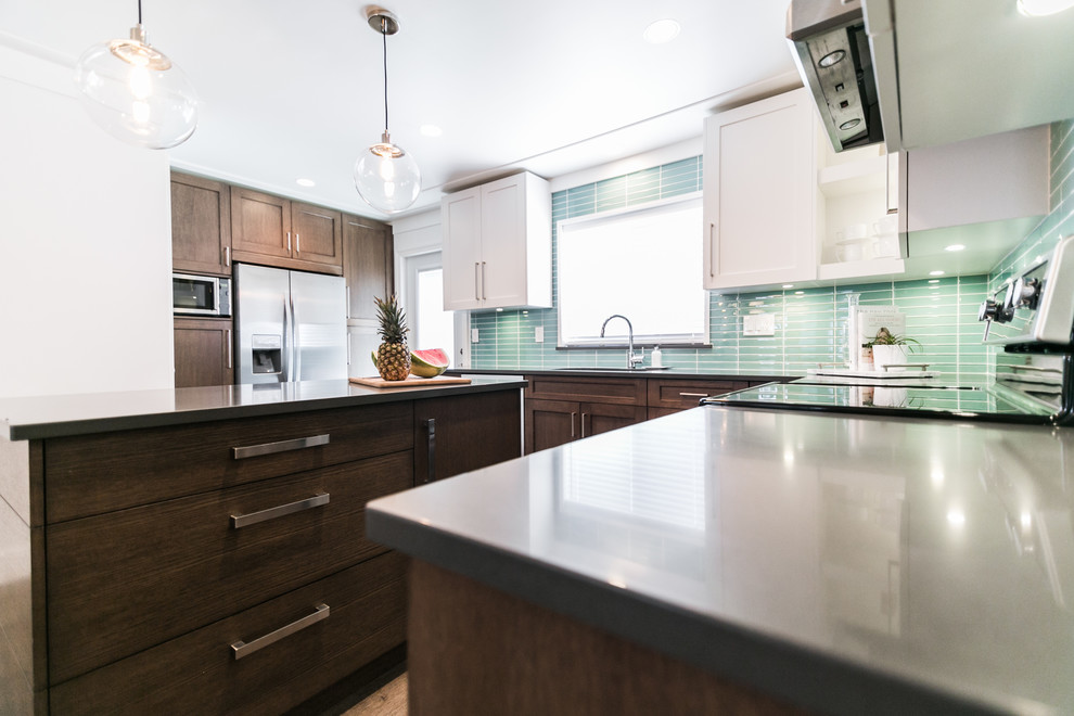 Enclosed kitchen - mid-sized transitional u-shaped dark wood floor and brown floor enclosed kitchen idea in Vancouver with flat-panel cabinets, dark wood cabinets, glass tile backsplash, a double-bowl sink, blue backsplash, stainless steel appliances and an island