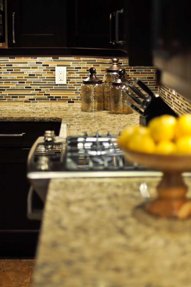 Kitchen - transitional cork floor kitchen idea in Ottawa with recessed-panel cabinets, brown cabinets, quartzite countertops, multicolored backsplash, mosaic tile backsplash, stainless steel appliances and an island