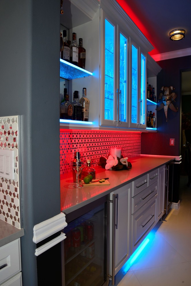 Mid-sized traditional single-wall wet bar in Seattle with raised-panel cabinets, white cabinets, multi-coloured splashback, mirror splashback, porcelain floors, white floor and white benchtop.