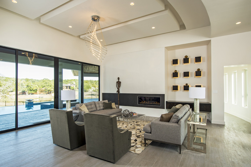 Design ideas for an expansive contemporary open concept living room in Austin with white walls, porcelain floors, a ribbon fireplace, a tile fireplace surround and no tv.