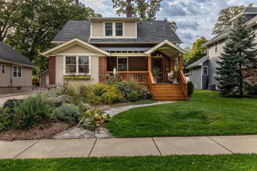 Brown one-story mixed siding and board and batten exterior home idea in Chicago with a tile roof and a gray roof