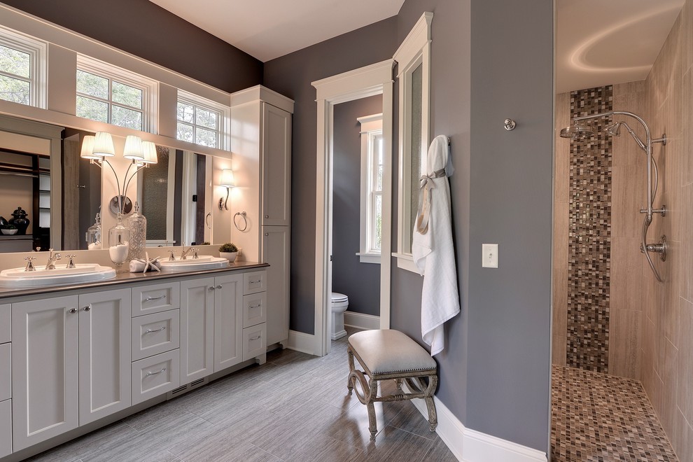 Traditional bathroom in Minneapolis with a drop-in sink, shaker cabinets, white cabinets, an alcove shower, beige tile and an enclosed toilet.