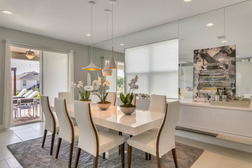 Inspiration for a contemporary dining room in Orlando with grey walls and grey floor.