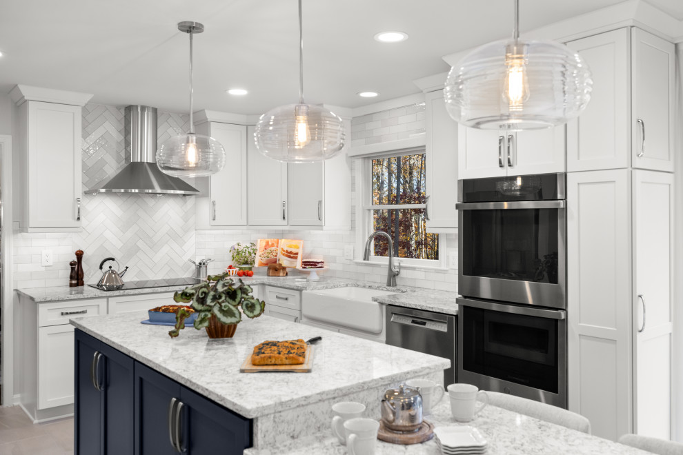 Mid-sized transitional kitchen photo in DC Metro with shaker cabinets, white cabinets, quartz countertops, porcelain backsplash, stainless steel appliances and an island