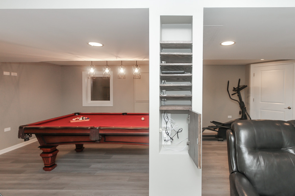 Design ideas for a mid-sized transitional fully buried basement in Chicago with a game room, grey walls, vinyl floors, no fireplace and grey floor.