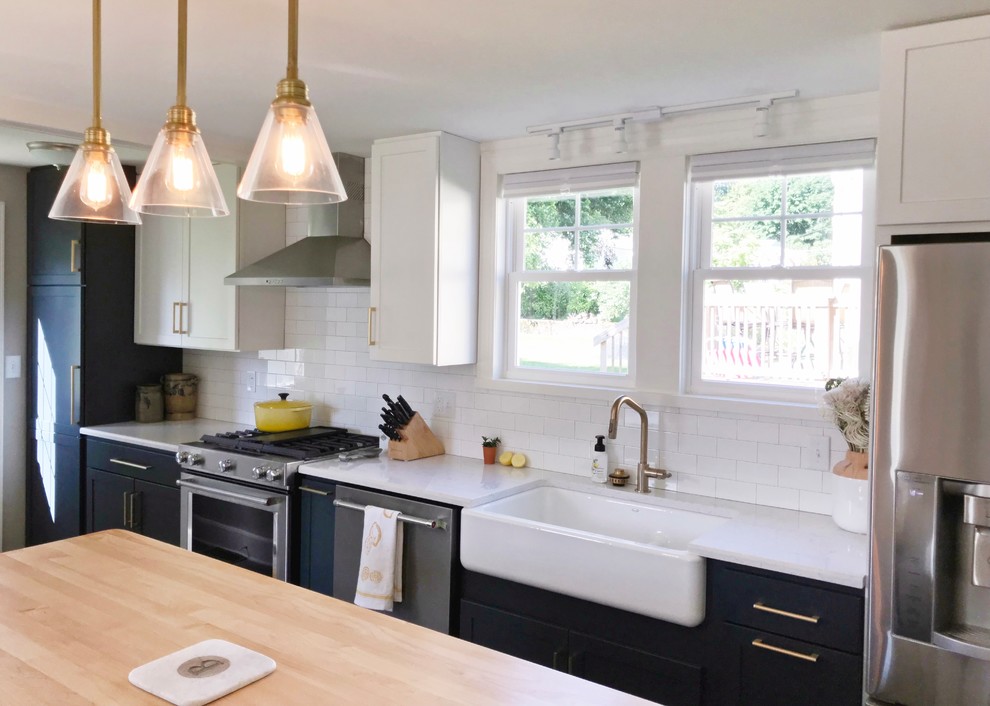 Inspiration for a transitional gray floor kitchen remodel with a farmhouse sink, quartz countertops and stainless steel appliances
