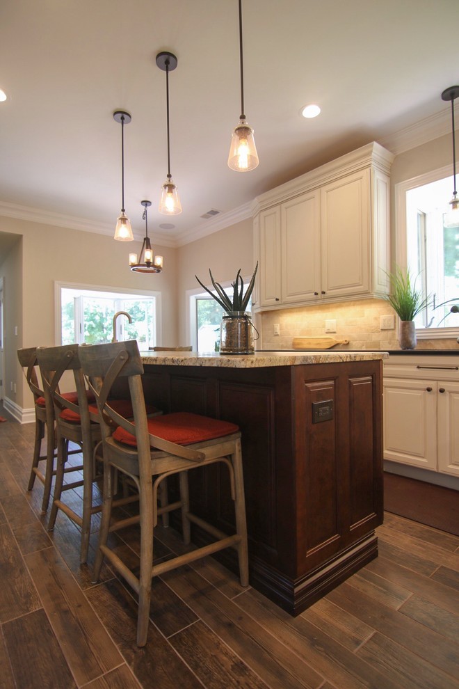Inspiration for a mid-sized rustic l-shaped dark wood floor and brown floor eat-in kitchen remodel in New York with an undermount sink, raised-panel cabinets, white cabinets, quartzite countertops, beige backsplash, stainless steel appliances, an island and beige countertops