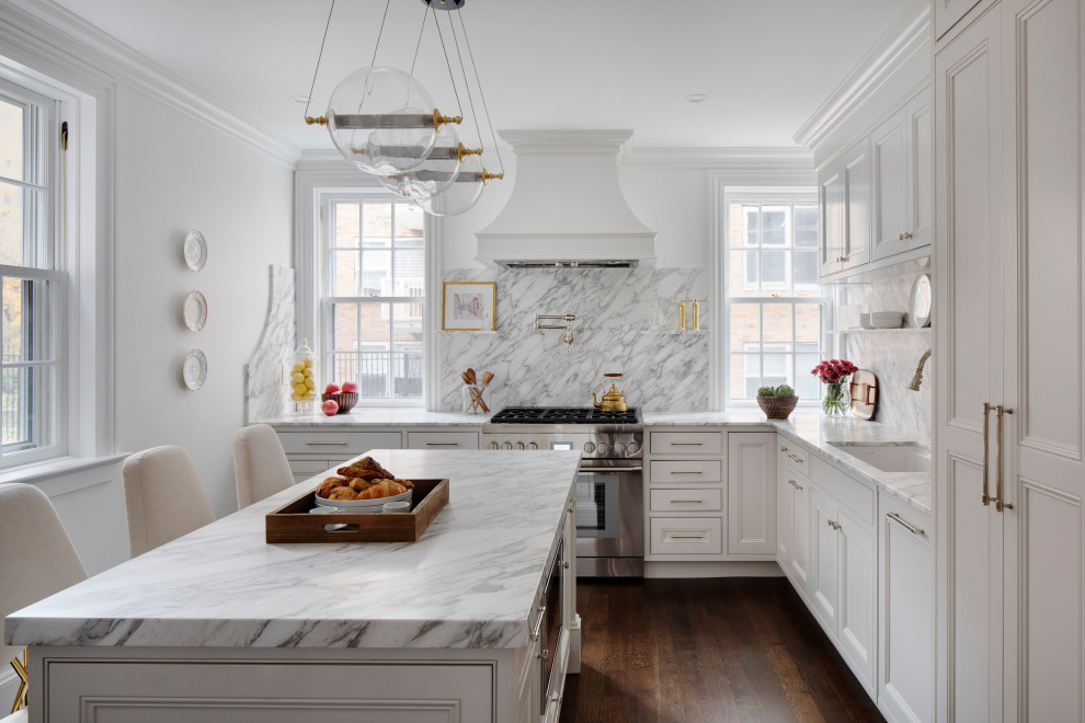 Inspiration for a small transitional l-shaped dark wood floor and brown floor enclosed kitchen remodel in Boston with an undermount sink, white cabinets, marble countertops, white backsplash, marble backsplash, paneled appliances, an island, white countertops and recessed-panel cabinets