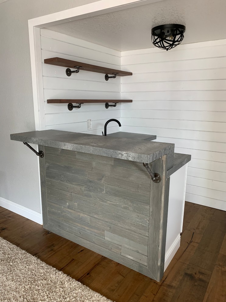 Inspiration for a small industrial l-shaped wet bar in Sacramento with an undermount sink, quartz benchtops, dark hardwood floors, brown floor and grey benchtop.