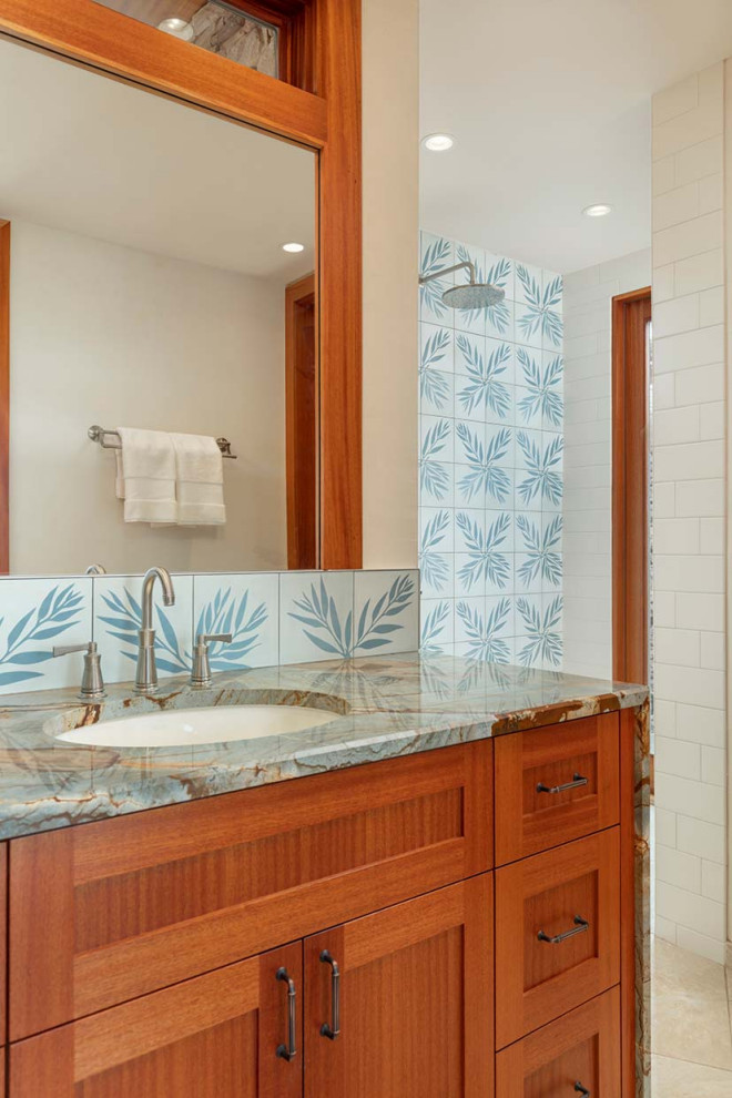 This is an example of a mid-sized tropical powder room in Minneapolis with a built-in vanity.