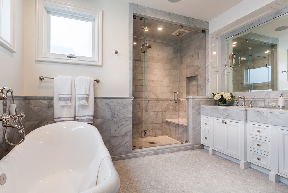 Design ideas for a large country master bathroom in Los Angeles with recessed-panel cabinets, white cabinets, a freestanding tub, an alcove shower, gray tile, marble, white walls, marble floors, an undermount sink, marble benchtops, white floor, a hinged shower door and white benchtops.