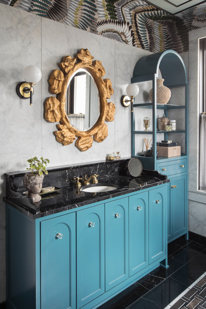 Eclectic multicolored tile and marble tile mosaic tile floor, single-sink and wallpaper claw-foot bathtub photo in St Louis with recessed-panel cabinets, blue cabinets, marble countertops and black countertops