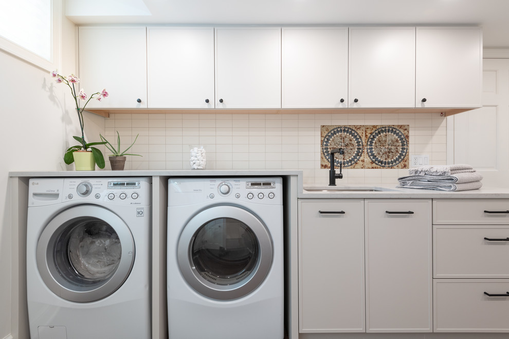 Inspiration for a mid-sized modern laundry room in DC Metro with white walls, dark hardwood floors and brown floor.