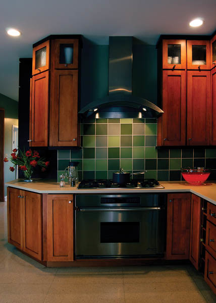 Huge transitional eat-in kitchen photo in Indianapolis with medium tone wood cabinets, green backsplash and black appliances