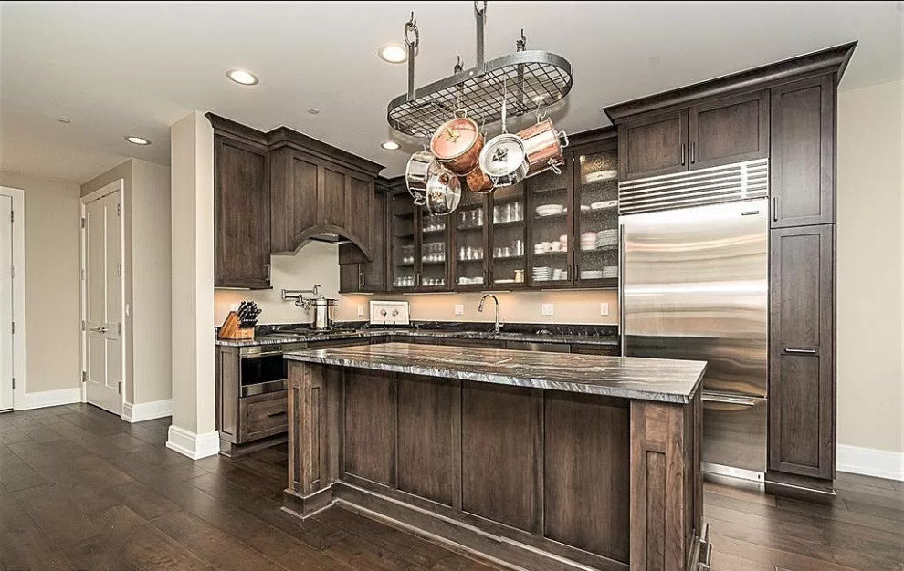 Mid-sized transitional l-shaped dark wood floor and brown floor open concept kitchen photo in Detroit with an undermount sink, flat-panel cabinets, dark wood cabinets, granite countertops, gray backsplash, granite backsplash, stainless steel appliances, an island and gray countertops