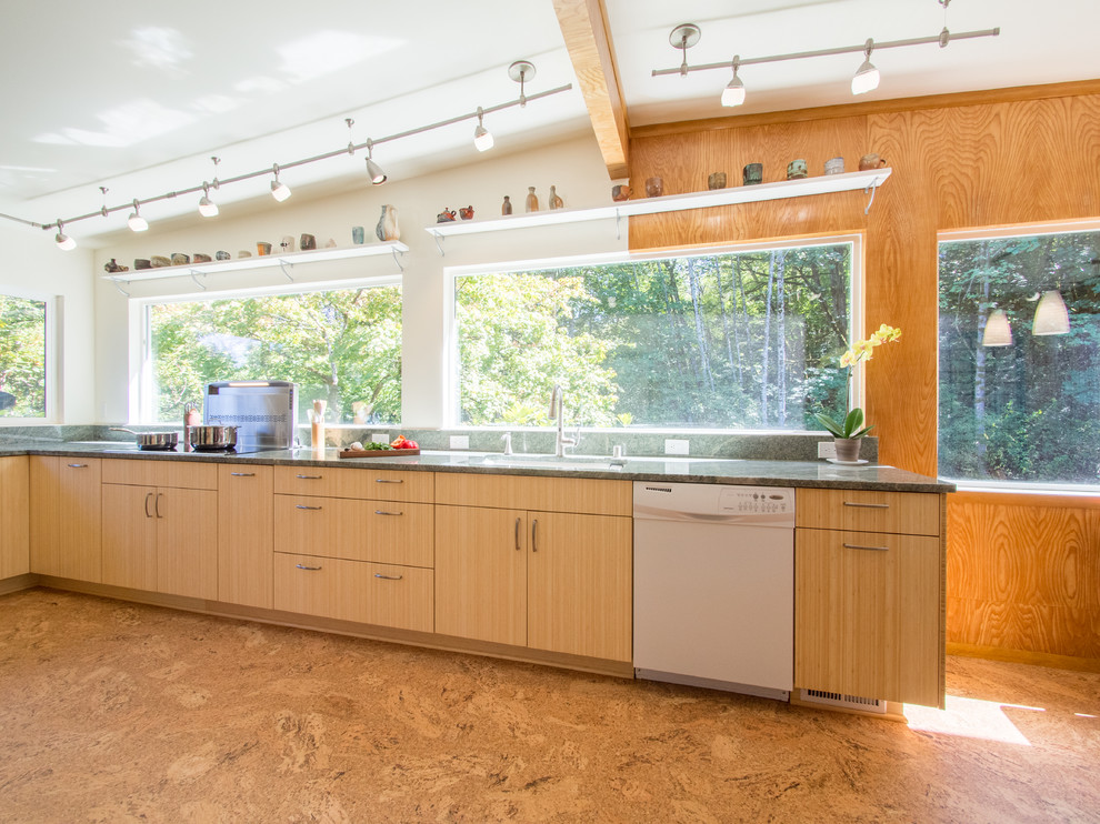 This is an example of a large midcentury u-shaped eat-in kitchen in Seattle with a single-bowl sink, flat-panel cabinets, light wood cabinets, granite benchtops, green splashback, stone slab splashback, white appliances, cork floors and no island.