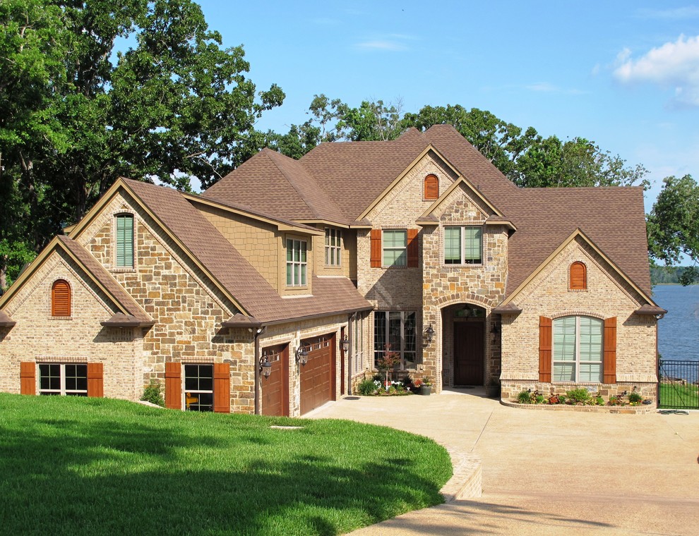 Photo of a large traditional two-storey brown exterior in Austin with mixed siding.