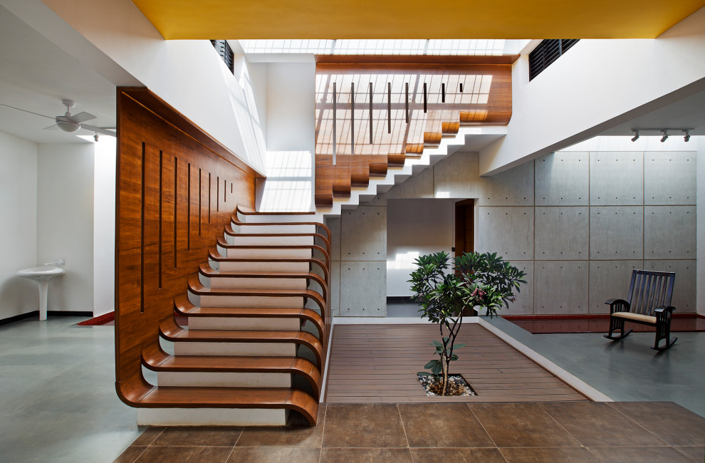 Photo of an Expansive contemporary Wood L-shaped staircase in Bengaluru.
