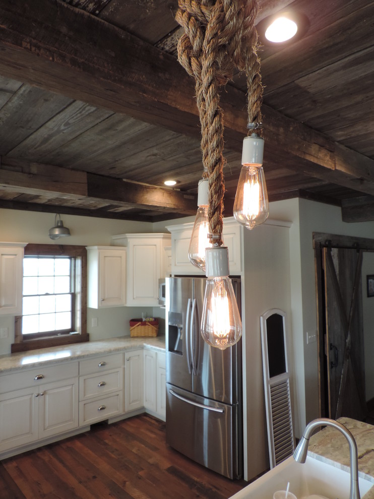 Inspiration for a large rustic u-shaped dark wood floor eat-in kitchen remodel with a farmhouse sink, raised-panel cabinets, white cabinets, marble countertops, stainless steel appliances and an island