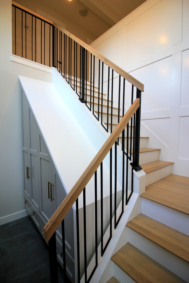 Large transitional wooden l-shaped mixed material railing staircase photo with painted risers