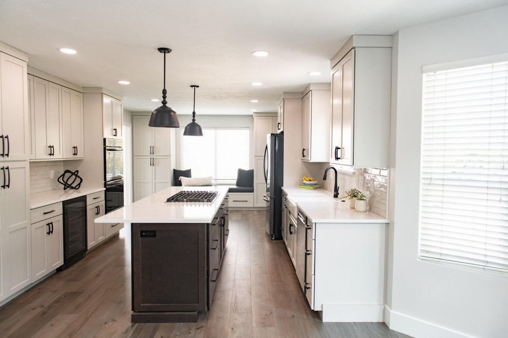 Mid-sized farmhouse galley eat-in kitchen photo in Salt Lake City with a farmhouse sink, shaker cabinets, gray cabinets, quartz countertops, white backsplash, an island and white countertops