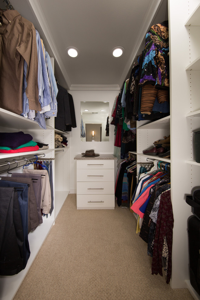 Design ideas for a small contemporary gender-neutral walk-in wardrobe in DC Metro with flat-panel cabinets, white cabinets and carpet.