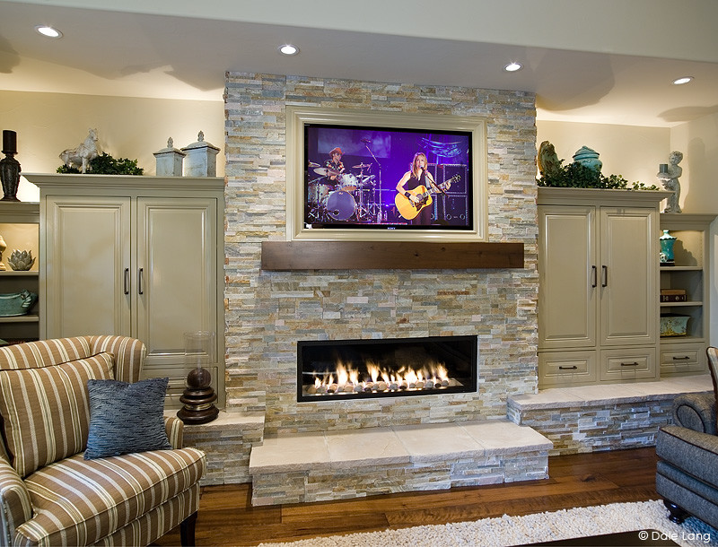 Inspiration for a mid-sized traditional open concept family room in Portland with beige walls, medium hardwood floors, a standard fireplace, a stone fireplace surround and a built-in media wall.