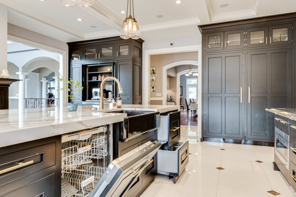 This is an example of an expansive mediterranean galley eat-in kitchen in Baltimore with a farmhouse sink, beaded inset cabinets, black cabinets, quartz benchtops, beige splashback, marble splashback, black appliances, marble floors, with island, multi-coloured floor and beige benchtop.