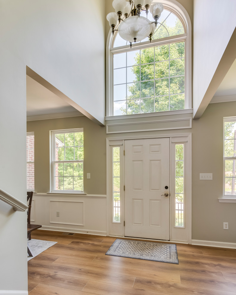 Large contemporary foyer in Baltimore with vinyl floors, yellow floor, white walls, a single front door and a white front door.