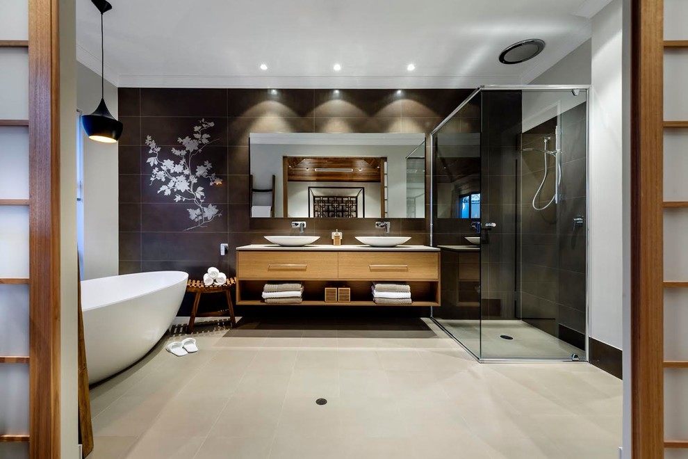 Large asian master bathroom in Perth with a vessel sink, flat-panel cabinets, medium wood cabinets, a freestanding tub, a corner shower, brown tile and white walls.