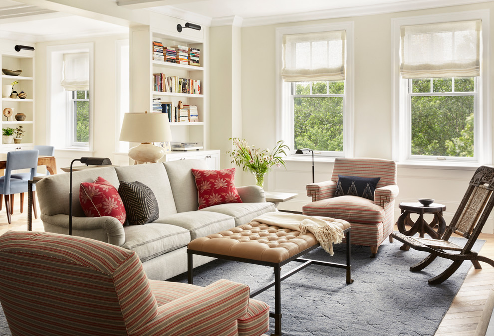 Photo of a large eclectic open concept living room in New York with white walls, light hardwood floors and beige floor.