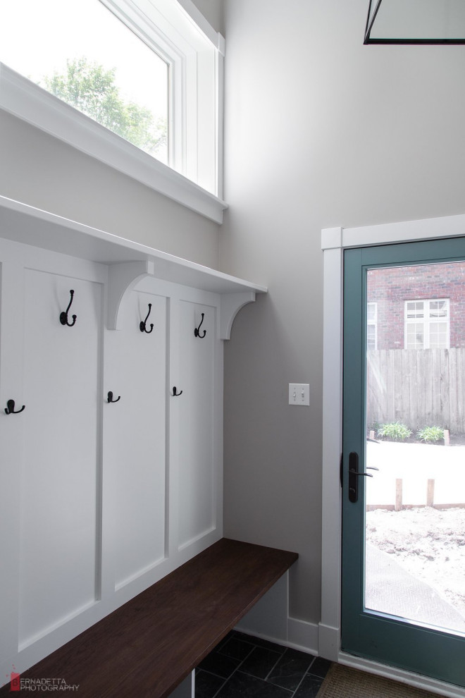 Photo of a small country mudroom in Chicago with grey walls, slate floors, a single front door, a blue front door, grey floor and panelled walls.