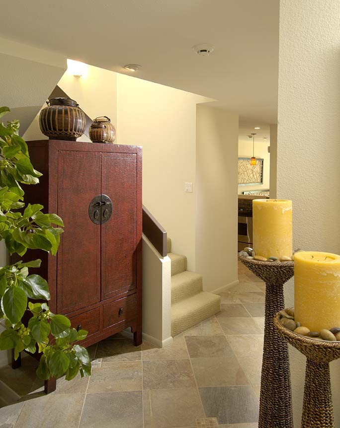 This is an example of an expansive asian hallway in Hawaii with white walls and slate floors.