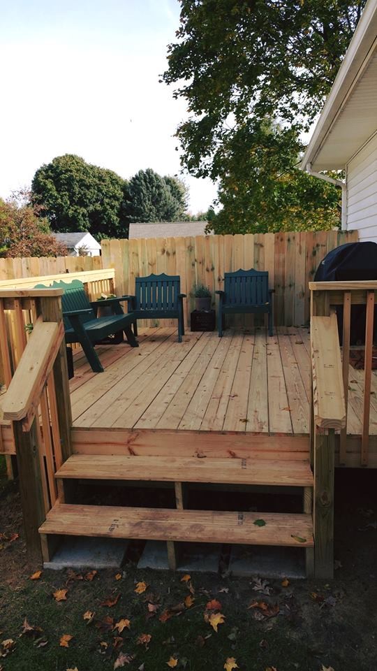 This is an example of a mid-sized backyard deck in Detroit with no cover.