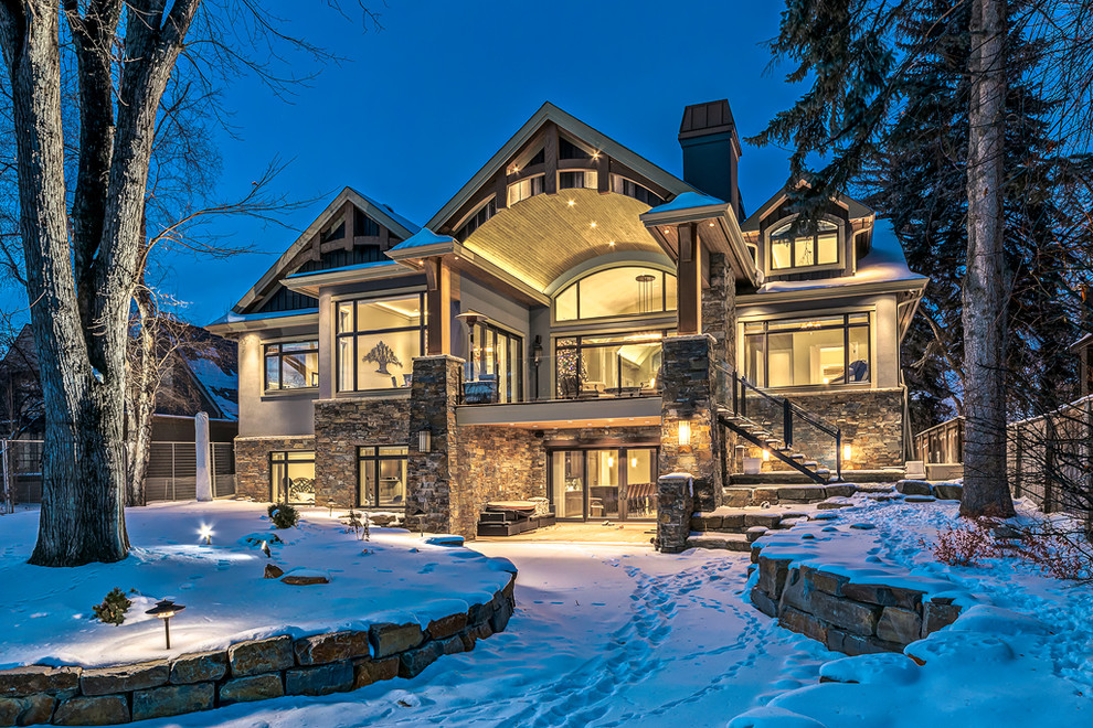 Inspiration for an expansive traditional one-storey grey exterior in Calgary with wood siding.