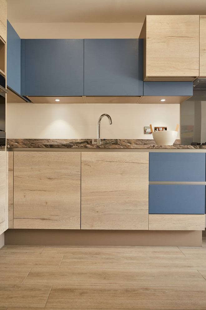 This is an example of a modern kitchen in London with flat-panel cabinets.