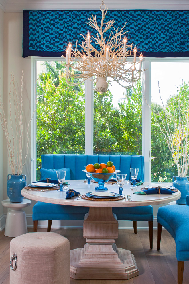 Inspiration for a beach style dining room in Tampa with beige walls and medium hardwood floors.