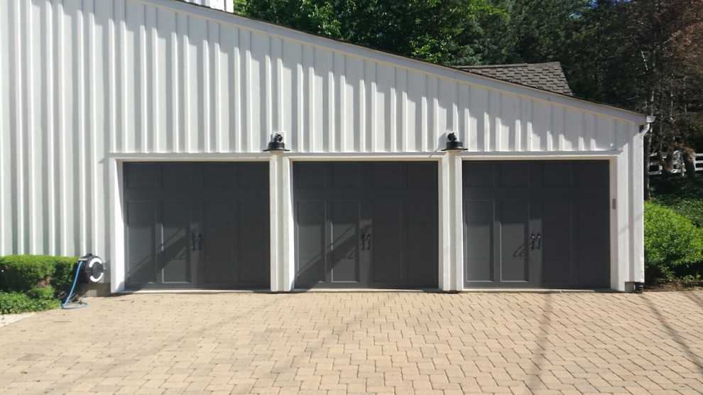 Photo of a large transitional attached three-car carport in Chicago.