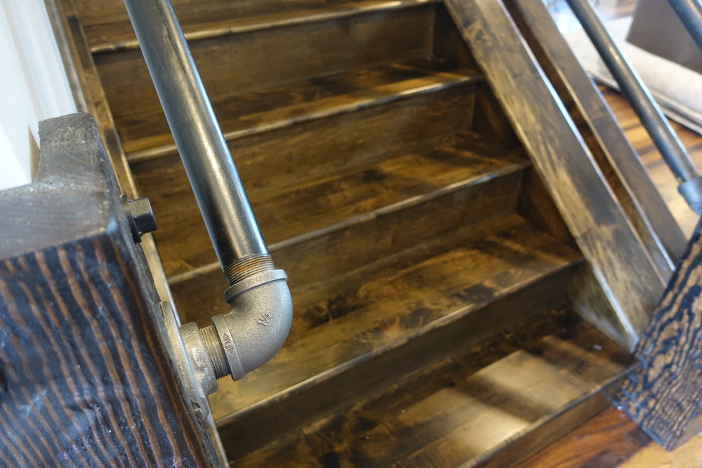 Design ideas for a large arts and crafts wood straight staircase in Denver with wood risers.