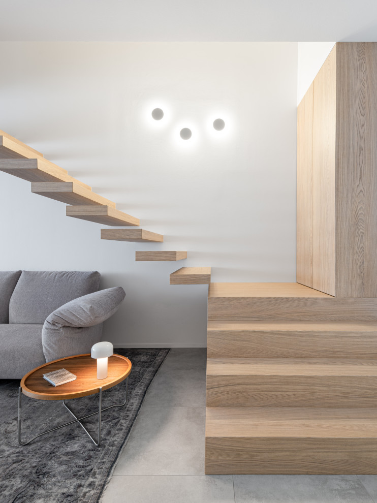 Design ideas for a large contemporary wood straight staircase in Venice with open risers.