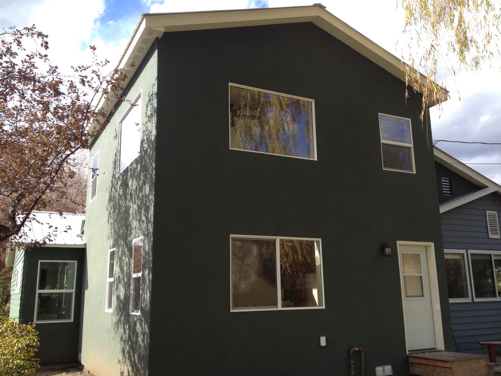 This is an example of a mid-sized one-storey stucco yellow exterior in Denver.