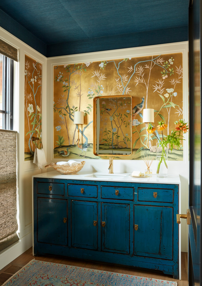 This is an example of a classic cloakroom in Denver with a submerged sink, marble worktops, brown floors, white worktops, a wallpapered ceiling, wallpapered walls, blue cabinets, a freestanding vanity unit, flat-panel cabinets and medium hardwood flooring.