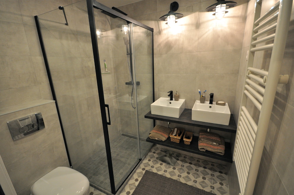 Design ideas for a small industrial master bathroom in Lyon with open cabinets, black cabinets, a curbless shower, a one-piece toilet, beige tile, ceramic tile, beige walls, cement tiles, a drop-in sink, tile benchtops, beige floor and a sliding shower screen.