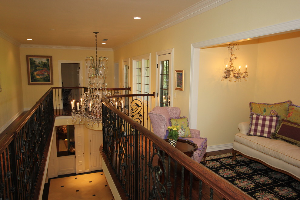 Mid-sized elegant ceramic tile and white floor foyer photo with yellow walls and a dark wood front door